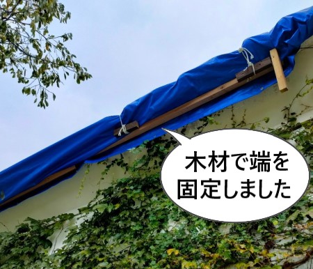 ブルーシートで屋根を仮養生　木材で端を固定